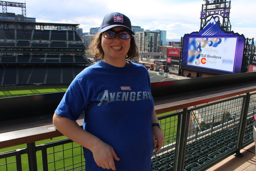 Danielle Solzman poses from The Rooftop at Coors Field.