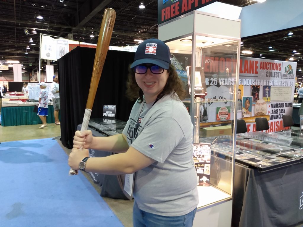 Danielle Solzman holds a Lou Gehrig game-used bat.